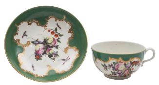 A First Period Worcester 'spotted fruit' teacup and saucer: painted with a variety of fruit and
