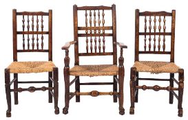 A harlequin set of seven early 19th Century ash and fruitwood spindle back dining chairs:,