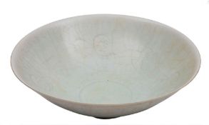 A Chinese Qingbai porcelain bowl: of circular form, covered in a crazed pale celadon glaze,