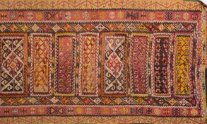 A Kelim flatweave:, the field with eleven oblong panels in varying colours with geometric designs,