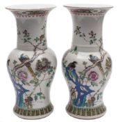 A pair of Chinese famille rose yen yen vases: painted with long-tailed birds amongst flowering