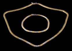A diamond mounted two-tone necklace together with a matching bracelet: set with round,