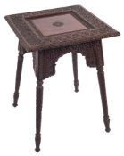 A middle Eastern carved rosewood occasional table: with square inset top above carved arched frieze