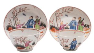 A pair of New Hall famille rose hardpaste teabowls and saucers: each painted with a garden scene