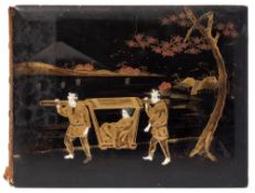 A Japanese lacquered photograph album: the front board decorated with a figure in a sedan chair