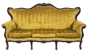 A carved and ebonised three seat settee in the French taste:,