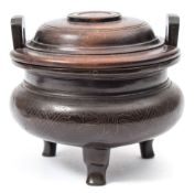 A small Chinese silver inlaid bronze tripod censer and wood cover: with flattened angular loop