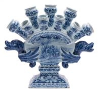 A Dutch blue and white delftware tulip vase: the body of arched flattened form with nine nozzles in