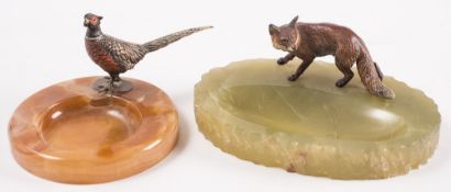 Two early 20th century cold painted bronze mounted onyx ashtrays:, one with a figure of a pheasant,