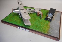A 1/48th diorama of a De Haviland DH9: with figures and car, mounted on a wood base.