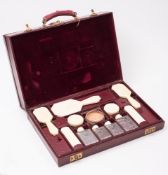A red leather vanity travelling case by Asprey, London:,