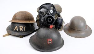 A group of four WWII period steel helmets:, in various condition,