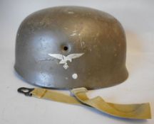A World War II period German paratrooper or Fallschirmjager helmet,: lacks liner.