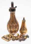 A 19th century copper powder flask: with embossed foliate decoration,