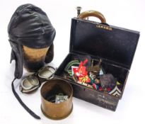 A group of miscellaneous militaria, including shoulder and cap badges,
