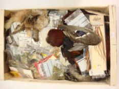 A collection of various fly tying equipment and accessories:, including a selection of feathers,