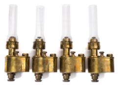 A set of four early 20th century Continental brass desk mounted oil lamps:,