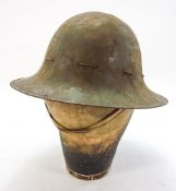 A WWII period British Military Brodie Helmet: with original liner and chin strap,