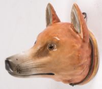 A 19th century Staffordshire fox head stirrup cup:, 10cm long.