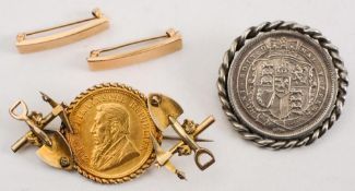 A South African 1894 gold half pound coin in a pick and shovel mount:,