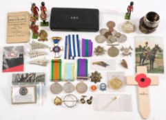 A collection of various militaria and related items:, including trench art,