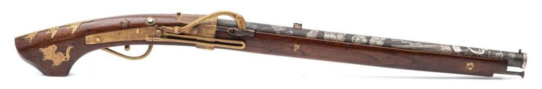 A reproduction Japanese matchlock (Tanegashima):, the 18 inch barrel with silvered decoration,