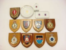 A collection of mess room badges on shield plinths:,