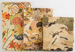 Three Japanese silk Obi (kimono sash):, one with cranes over waves, another with decorated fans,