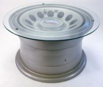 A Boeing aeroplane wheel converted to a coffee table: powder coated in a silver colour and fitted