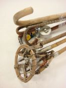Three pairs of wooden skis:, together with three ski poles and a group of walking sticks etc.