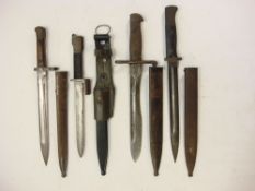 A group of four bayonets:, including a German K98 pattern bayonet and Spanish Model 1893 bayonet.