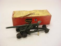 A Britains 155mm gun in original box:, green with black treaded tyres, barrel clamp,