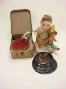 A child's tinplate rexine cased gramophone:, together with a group of records,