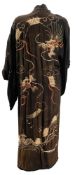 A Chinese black silk and gilt dragon embroidered house coat: together with an ivory silk and floral