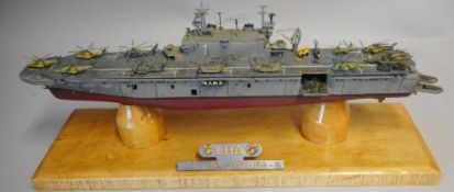 A model of the USS Saipan LHA-2:mounted on a wood base.