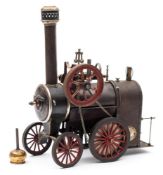 Ernst Plank for Gamage's, a live steam traction engine: of traditional design with single piston,