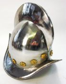 A reproduction Spanish morion helmet:, with high comb and brass decoration, 29cm high.