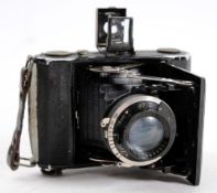 A Zeiss 'Ikonta' pocket camera:, in black, fitted 70mm lens.