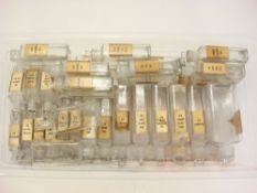 A collection of thirty-four rectangular pharmaceutical bottles:,