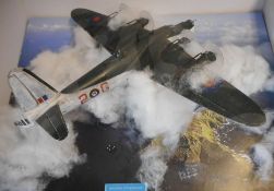 A 1/72nd diorama of a Sunderland flying boat breaking through cloud: mounted on a wood base.