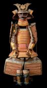 A Japanese Taisho Period O-yoroi (Samurai armour):, the kabuto with gilt brass mandate and mon,