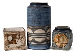Three Troika pottery vases: comprising a cylinder vase decorated with a band of discs bisected by