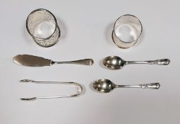 Two silver napkin rings, two silver teaspoons, a silver butter knife and pair silver sugar nips