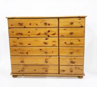 Pair of contemporary pine three-drawer bedside chests raised on bun feet and a pine chest of six
