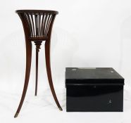 Edwardian mahogany jardiniere stand and a black enamelled tin deed box (2)