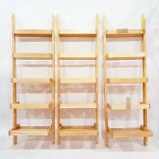 Three beech standing wall shelves of tapering ladder design, of five shelves each, height 190cm (