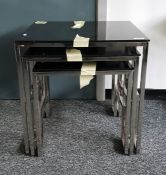 LOT WITHDRAWN Two nests of three black glass occasional tables on chrome steel supports, 45cm (6) (