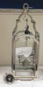 Four-branch hanging lantern within a glazed steel frame, height 85cm (VAT payable on hammer)