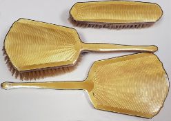 Silver and enamel dressing table set of three pieces, viz:- hand mirror, hairbrush and clothes