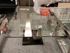 Rectangular glass top coffee table with bevelled edge, raised on curved chrome steel support, length